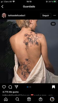 the back of a woman's body with flowers on it