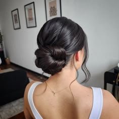 a woman with her hair in a low bun