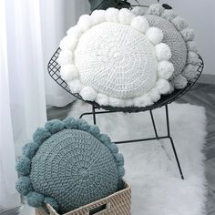 two crocheted pom - poms sitting next to each other on a chair