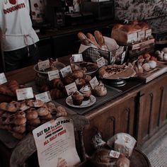 breads and pastries on display in a bakery