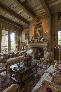 a living room filled with furniture and a fire place in the middle of a room