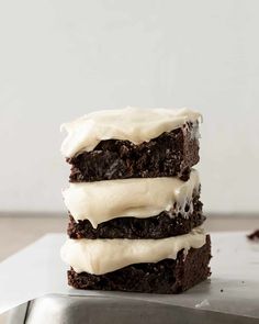 three brownies with white frosting stacked on top of each other