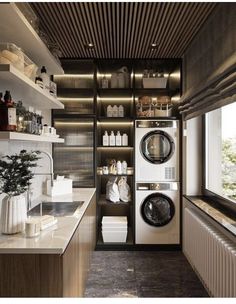 a washer and dryer in a room next to a window with open shelves