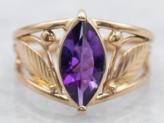 This pretty vintage amethyst ring has a lovely purple amethyst in the center, that really flashes and flickers with vibrant violet reflections! Set into a lovely vintage mounting with engraved leaf shoulders and simple prongs, this vintage ring is a beautiful addition to anyone's collection! Metal: 14K Yellow Gold Gem: Amethyst .87 Carats Gem Measurements: 5.4 x 10.3 mm, Marquise Cut Ring Size: 5.25 Marks: "14K" Stamped on the inside band SKU #: A27208 Each piece has been identified and graded b Vintage Amethyst Ring, Amethyst Ring Vintage, Marquise Cut Rings, Pocket Watch Chain, Watch Chain, Yellow Gold Ring, Marquise Cut, Vintage Ring, Amethyst Ring