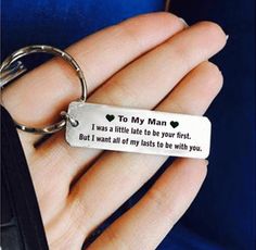 a person holding a keychain that says to my man i was little late to be your first but i want all of my lasts to be with you