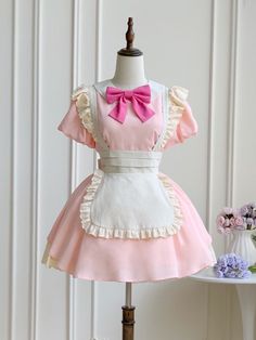 This price includes a dress and a pink bowknot.  Get ready to channel your inner maid with this stunning Pink Lolita Fashion Apron Dress. Complete with a charming bowknot on the neckline, this dress is perfect for anyone looking to add a touch of elegance and whimsy to their wardrobe. Whether you're attending a tea party or simply want to showcase your love for Lolita fashion, this apron dress is sure to turn heads and make you feel like a true fashionista.   	 		 			Size 			S 			M 			L 		 		 			Full Length 			74 			77 			80 		 		 			Bust 			85 			90 			95 		 		 			Hem Circumference 			248 			253 			258 		 		 			Neck Circumference 			44 			45.5 			47 		 		 			Shoulders 			33 			35 			37 		 		 			Sleeve Length 			21 			22 			23 		 		 			Waist 			65 			70 			75 Pink Kawaii Dress For Tea Party, Pink Maid Dress Aesthetic, Pink And Blue Maid Dress, Kawaii Ruffled Dresses For Cosplay Events, Kawaii Ruffle Costume Dress, Apron Fashion, Fashion Apron