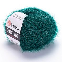 a ball of yarn that is green and has some glitter on the end of it