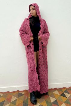 Introducing our one-of-a-kind Maxi Woolen Crochet Cardigan, a statement piece that beautifully blends vintage charm with contemporary flair. Repurposed from hand-knit  vintage warn pink crochet fabric with  a striking pattern. The maxi length adds a touch of bohemian elegance, making it perfect for layering over your favorite outfits.  Whether you're dressing up for a special occasion or adding a cozy layer to your everyday ensemble, this cardigan is designed to elevate your style with its uniqu Crochet Cozy Cardigan, Oversized Long Pink Cardigan, Bohemian One-size Knitted Sweater Coat, One Size Long Knitted Sweater Coat, Long Pink Beach Outerwear, Bohemian Oversized Hand Knitted Sweater Coat, Handmade Long Sweater Coat For Winter, Cozy Long Pink Outerwear, Bohemian Hand Knitted Sweater Coat