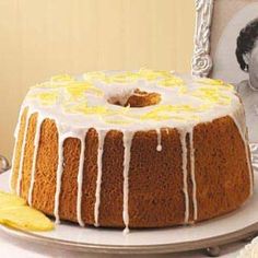 a bundt cake with lemon drizzled on top sitting on a plate