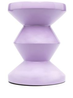 a purple vase sitting on top of a white table