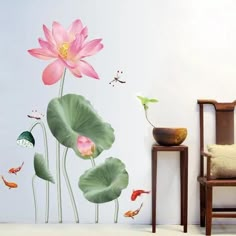 there is a pink flower and some fish in the pond wall decal on this room