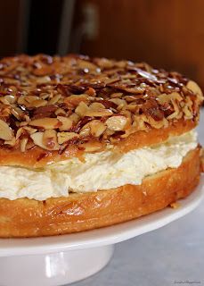 a cake with nuts on top sitting on a plate