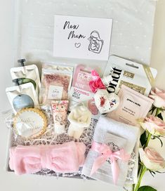 a box filled with lots of different items next to a sign that says new mum