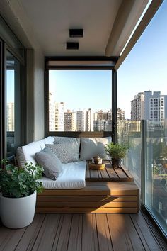 a couch sitting on top of a wooden floor next to a window filled with lots of windows