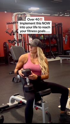 a woman is sitting on a bench in the gym