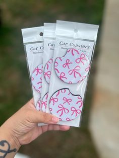 three pink bows are on the back of these car coasters, and one is for sale