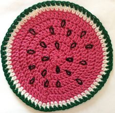 a crocheted watermelon dishcloth on a white surface