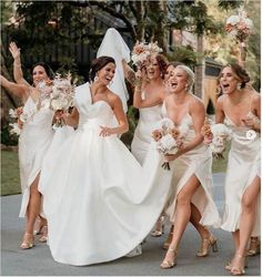 a group of bridesmaids walking down the street