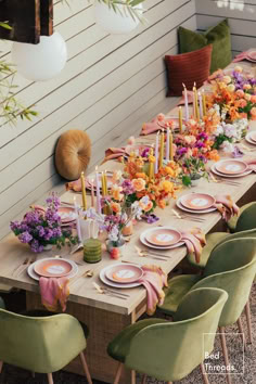 a long table with plates and flowers on it