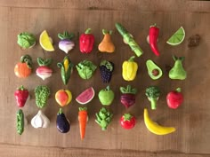 various fruits and vegetables are arranged on a wooden surface