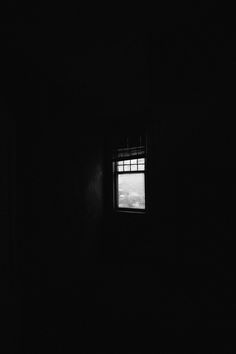 a dark room with a small window in it