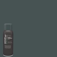 a bottle of black paint on a gray background with the words behrt in it