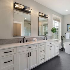 a large bathroom with double sinks and mirrors