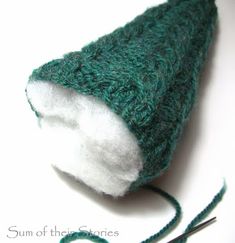 a close up of a green and white knitted object