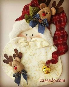 a santa clause with two stuffed animals hanging from it's side on a wall