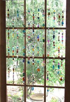 an open window with beads hanging from it