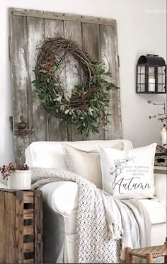 a living room with white furniture and wreath on the wall