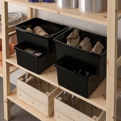 two bins are sitting on top of a shelf in a storage area with other containers