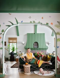 a woman sitting on top of a couch in a living room