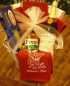 a basket filled with wine and snacks on top of a table