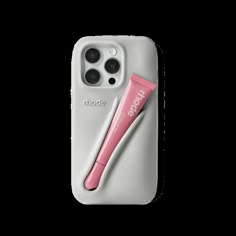 an iphone case with a pink toothbrush in it and the phone holder attached to it