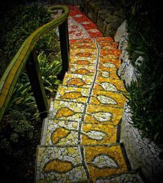 an artistic walkway made out of mosaic tiles