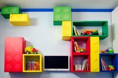 colorful shelves with legos and toys on them in a child's playroom