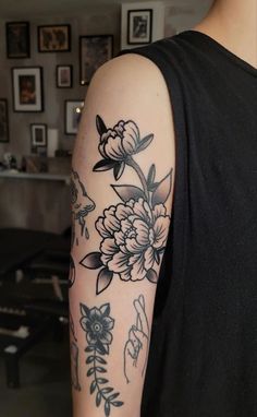 a man with a flower tattoo on his arm