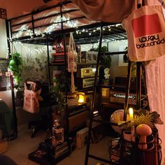 a room filled with lots of furniture and lights on the ceiling next to a window