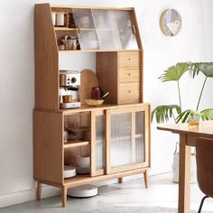 a wooden cabinet sitting next to a dining room table