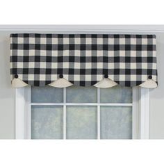 a black and white checkered valance hanging on the side of a window