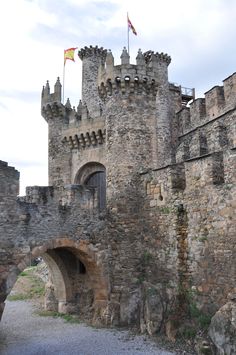 an old castle with stone walls and gates