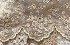 an old lace curtain with flowers on it