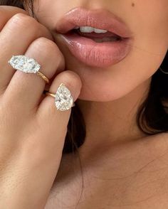 a close up of a person with a ring on their finger and her hand near her face