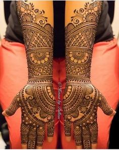 two hands with henna designs on them