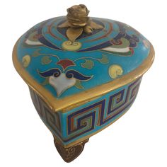 a blue and gold box with a flower on top