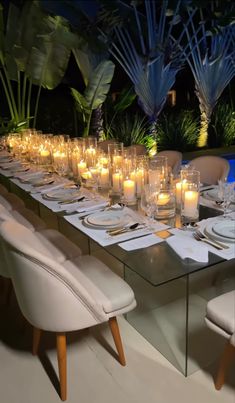 a long table is set with candles and place settings for dinner guests to enjoy the night