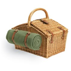 a wicker picnic basket with green blanket