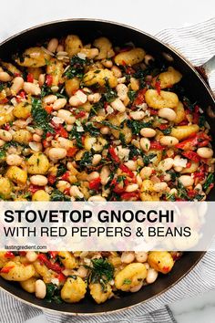 stovetop gnocchi with red peppers, beans and spinach in a skillet