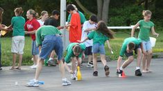 a group of children playing with cones in the street